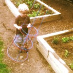 Child with tomato cage at Glenside Garden