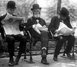 Men on park bench reading newspapers