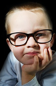 a little boy wearing eye glasses